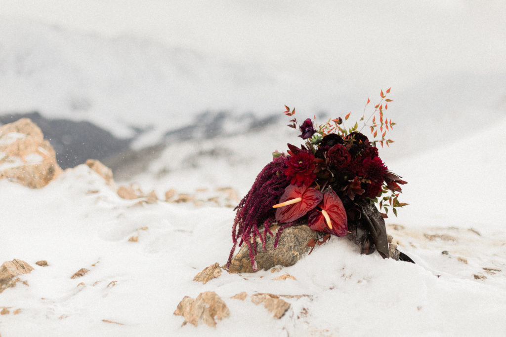 beautiful deep red bouquet from The Perfect Petal, denver colorado florist in winter elopement at Loveland Pass by photographer Diana Coulter