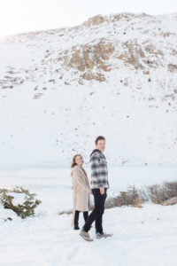 Couple walking through the mountains after surprise mountaintop proposal on Loveland Pass in Breckenridge, Colorado.

