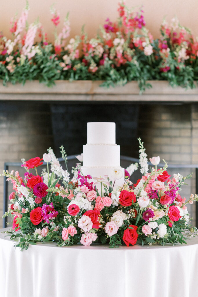 barbie colored flowers stunning mix of light and hot pink florals surrounding a timeless 3 tiered cake at the Broadmoor in Colorado Springs, CO,